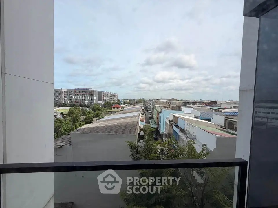 Stunning urban view from a modern balcony overlooking cityscape and rooftops, perfect for city living.