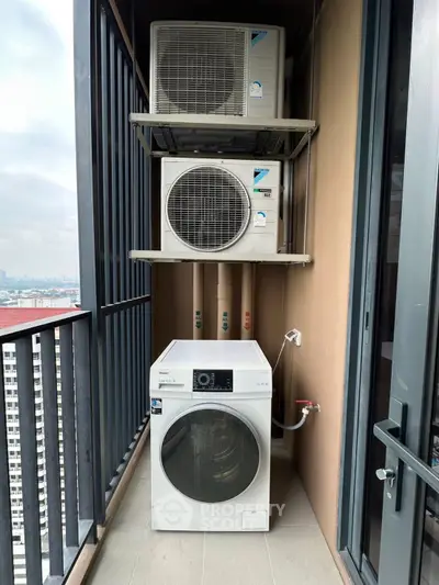 Compact balcony with air conditioning units and washing machine in urban apartment.
