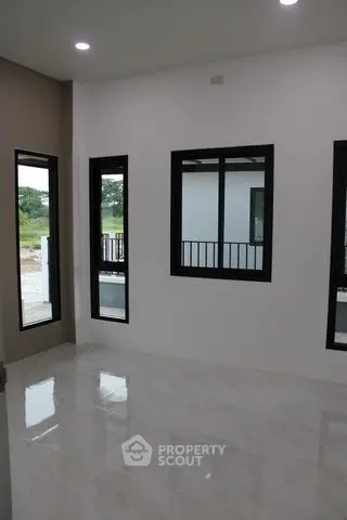 Spacious modern room with large windows and glossy marble flooring