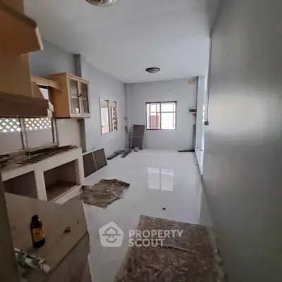 Spacious kitchen with potential for renovation, featuring ample natural light and open layout.