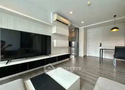 Modern living room with sleek design, large TV, and open layout in a stylish apartment.
