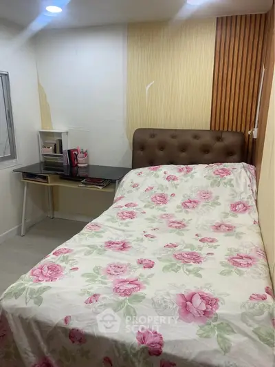 Cozy bedroom with floral bedding and modern desk setup