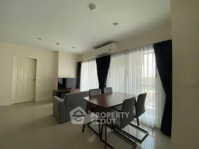 Modern living room with dining area and natural light