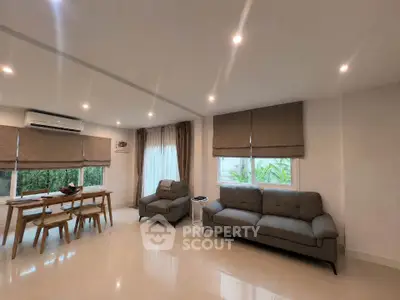 Spacious modern living room with elegant furniture and large windows for natural light.