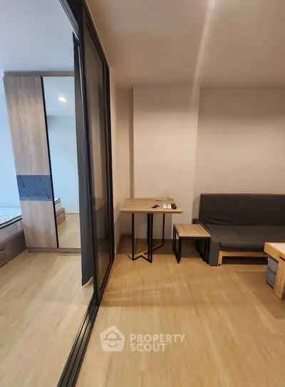 Modern apartment interior with sleek furniture and wooden flooring