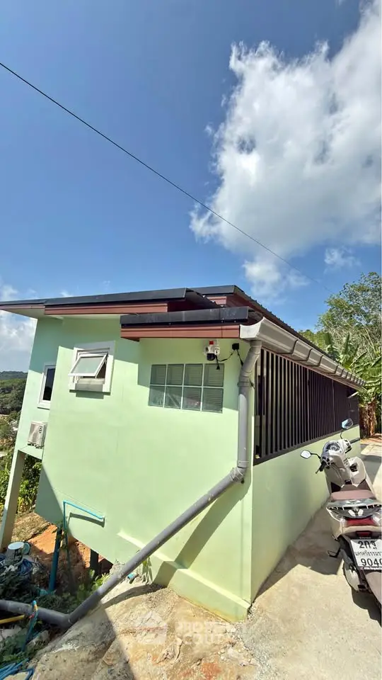 Charming hillside home with modern exterior and scenic views, perfect for tranquil living.