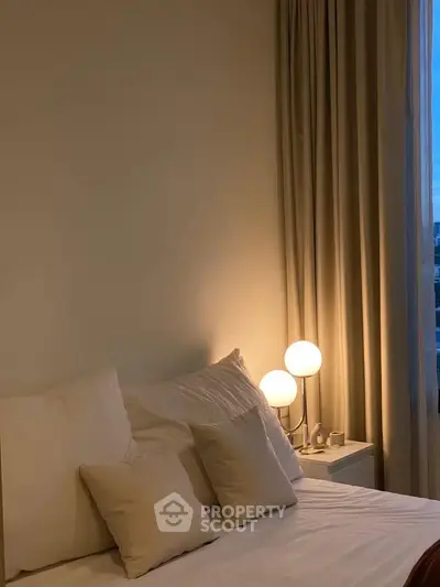 Cozy bedroom with soft lighting and elegant decor, perfect for relaxation.