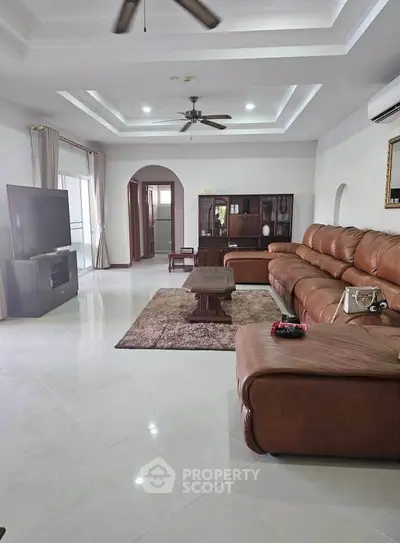 Spacious living room with leather sectional sofa and modern decor