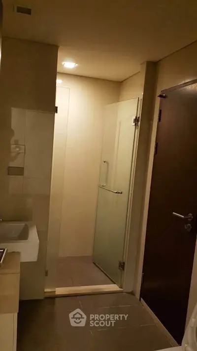 Modern bathroom with glass shower door and sleek fixtures