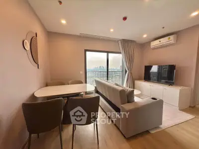 Modern living room with city view, featuring stylish furniture and elegant decor.