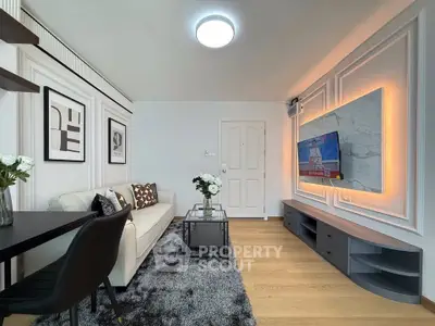 Modern living room with stylish decor and wall-mounted TV