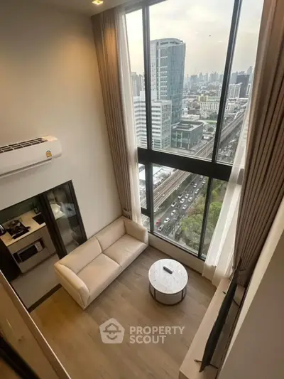 Modern loft apartment with floor-to-ceiling windows and city view