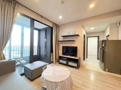 Modern living room with balcony access and stylish decor in a contemporary apartment.