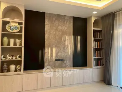 Elegant living room with built-in shelves and modern decor, perfect for stylish living.