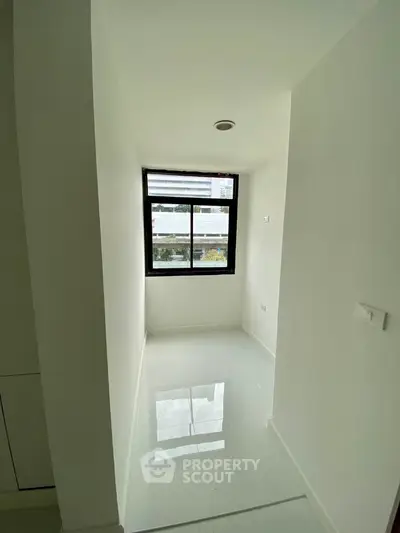 Bright minimalist room with large window and glossy white floor
