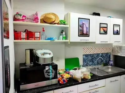 Charming kitchen with modern appliances and ample storage space, perfect for culinary enthusiasts.