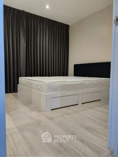 Modern minimalist bedroom with sleek flooring and elegant curtains
