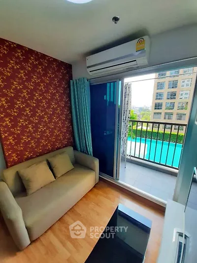 Modern living room with pool view and balcony access in a stylish apartment.