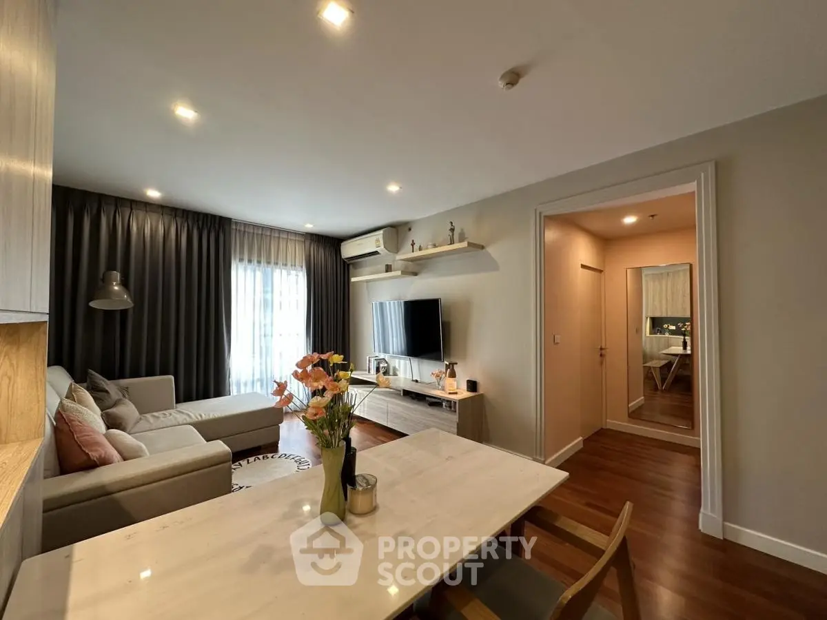 Modern living room with cozy sofa, stylish decor, and natural light