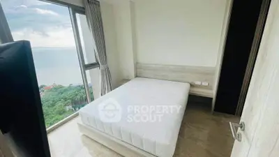 Spacious bedroom with stunning ocean view and modern minimalist design.