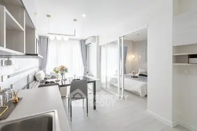 Modern open-layout kitchen and living area with elegant decor and natural light