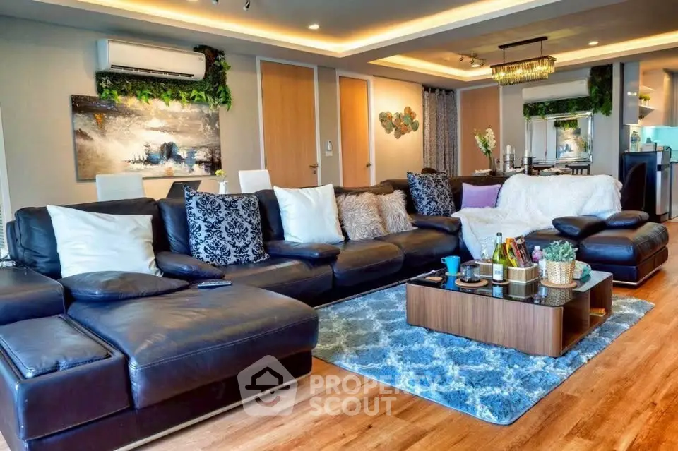 Luxurious living room with elegant decor, plush leather sofas, and ambient lighting in a modern apartment.