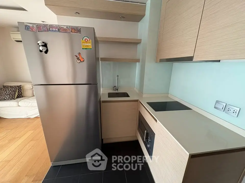 Modern kitchen with sleek appliances and minimalist design in a stylish apartment.