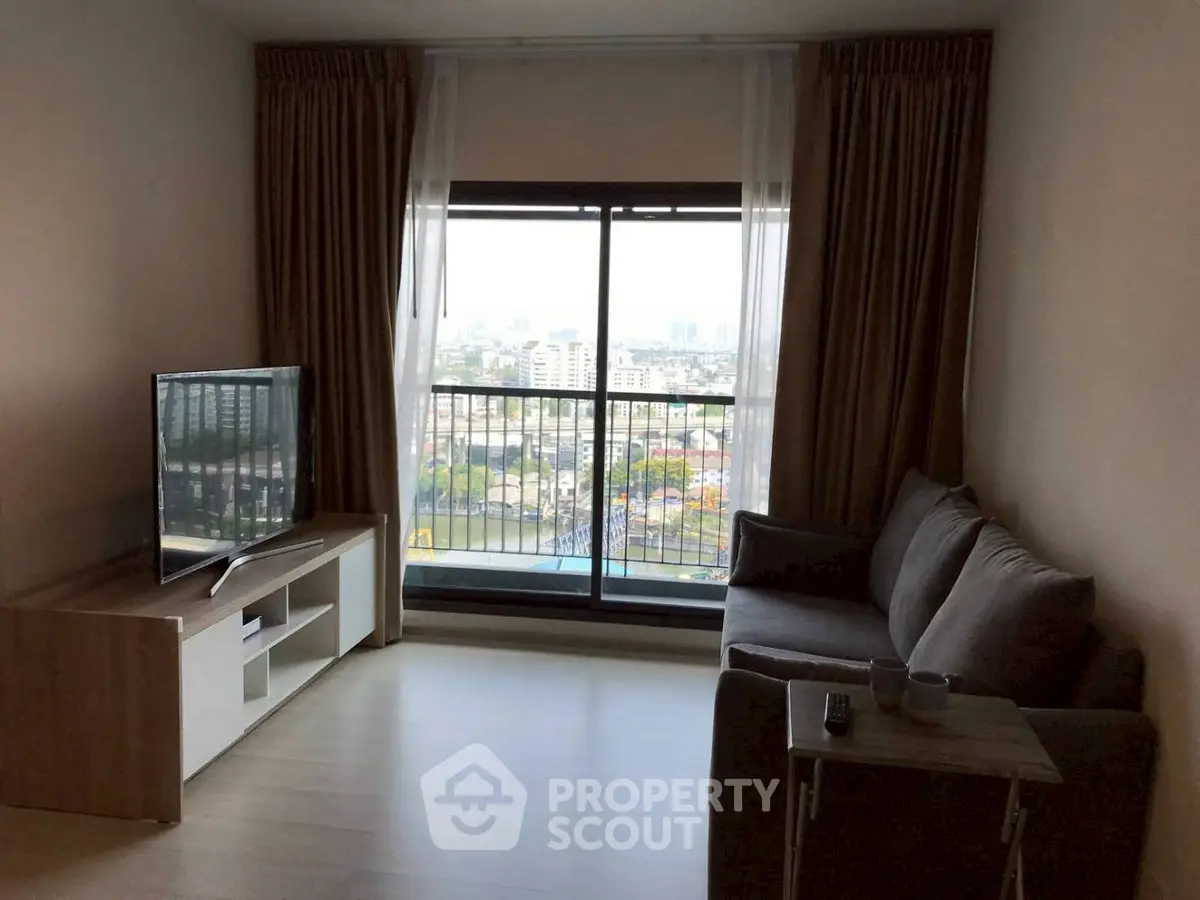 Cozy living room with city view, modern sofa, and flat-screen TV, perfect for relaxation.
