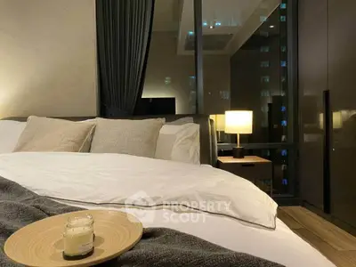 Luxurious bedroom with modern decor and city view, featuring cozy bedding and ambient lighting.