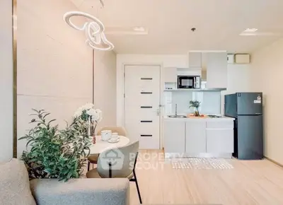 Modern open-plan kitchen and dining area with stylish decor and appliances.