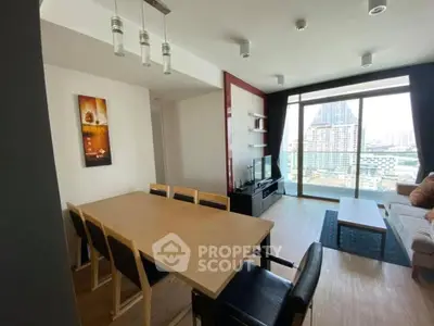 Modern living room with dining area and city view from large windows.