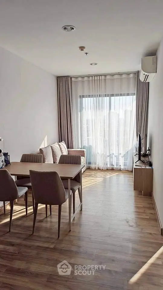 Bright and airy living room with modern furniture and large window view.