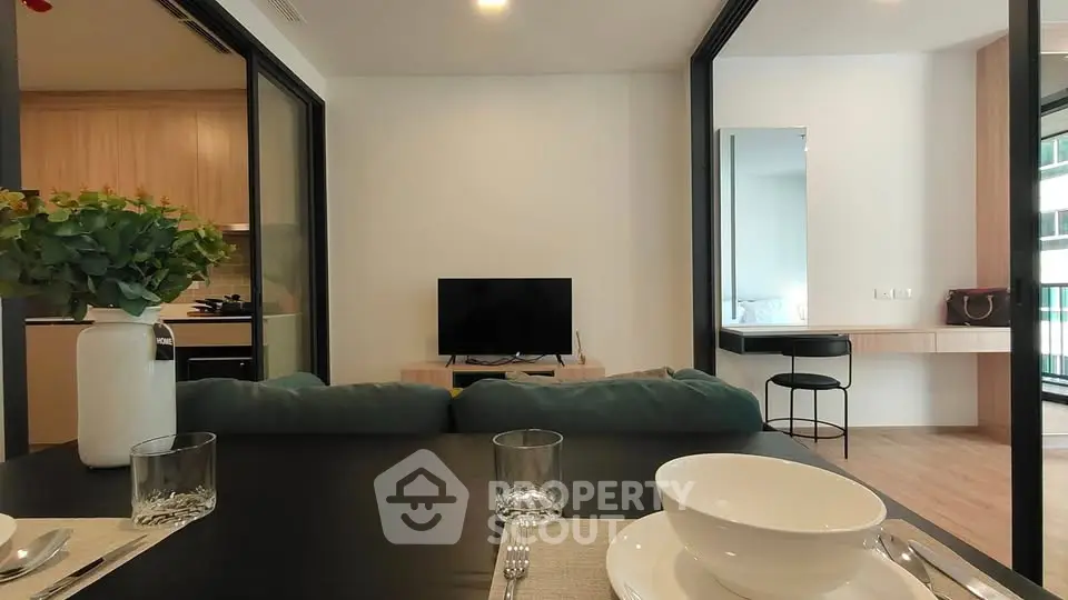 Modern living room with open kitchen and stylish decor in a contemporary apartment.