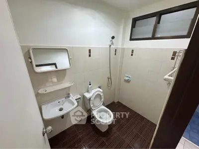 Modern bathroom with sleek design and efficient layout, featuring a shower and toilet.