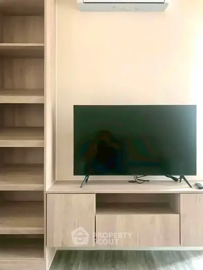Modern living room with sleek TV unit and built-in shelving