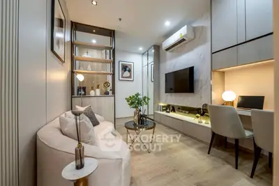 Modern living room with stylish decor, featuring a cozy sofa, wall-mounted TV, and a compact study area.