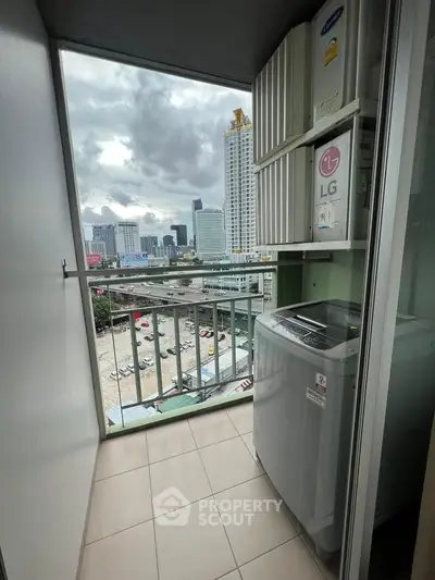 High-rise balcony with city view and washing machine, perfect for urban living.