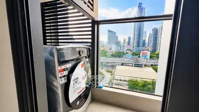 Modern condo balcony with washing machine and stunning city skyline view