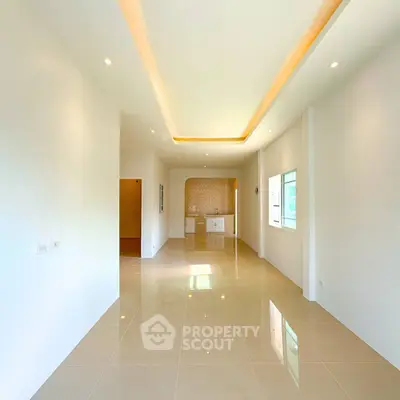 Spacious modern living room with sleek tile flooring and recessed lighting