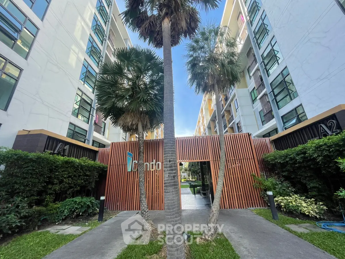 Modern condo entrance with lush greenery and contemporary design
