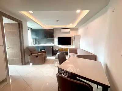Modern living room with sleek furniture and open kitchen layout