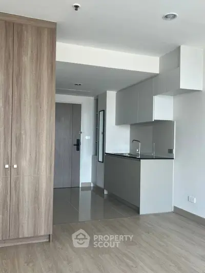 Modern minimalist kitchen with sleek cabinetry and wood flooring