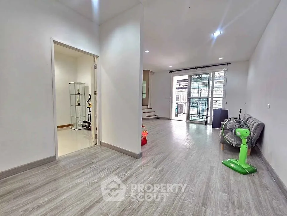 Spacious modern living room with wooden flooring and large windows
