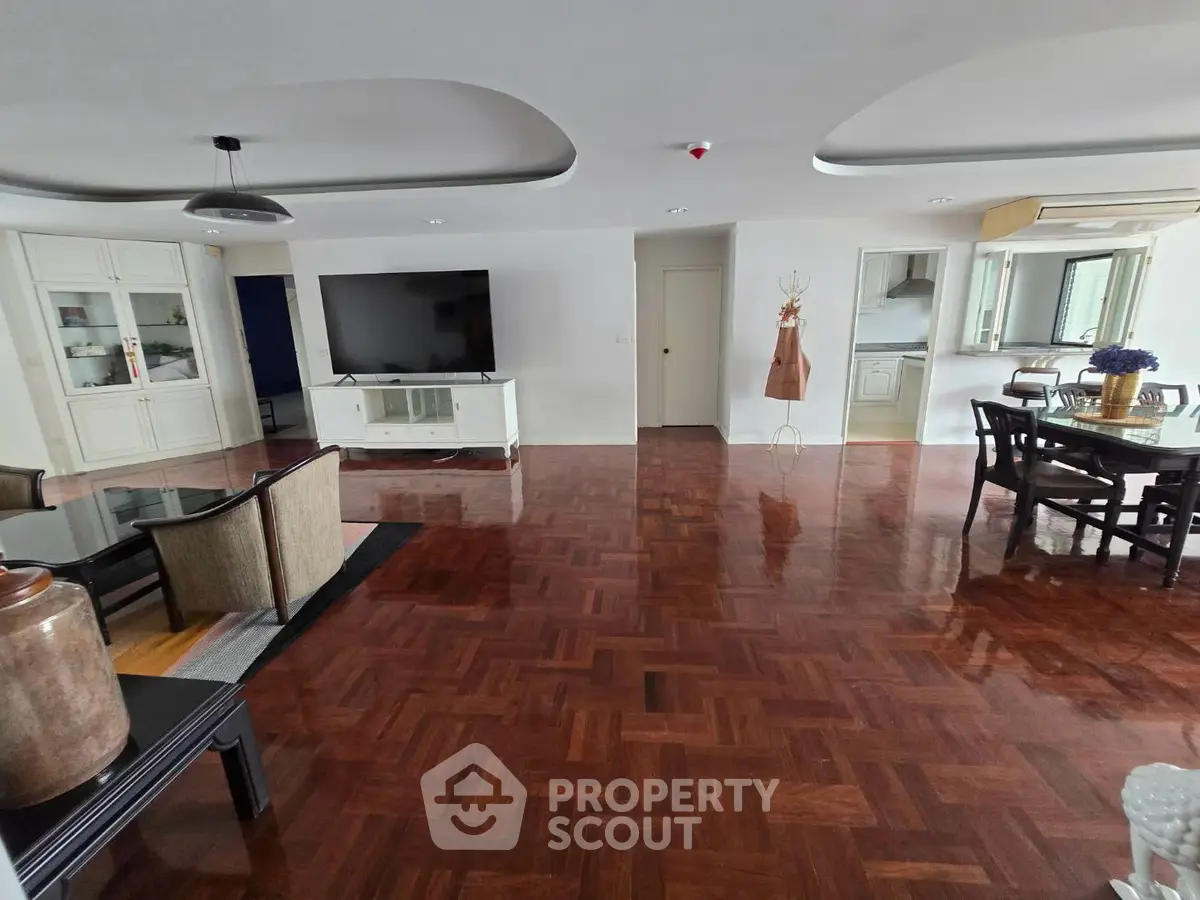 Spacious living room with elegant wooden flooring and modern furniture