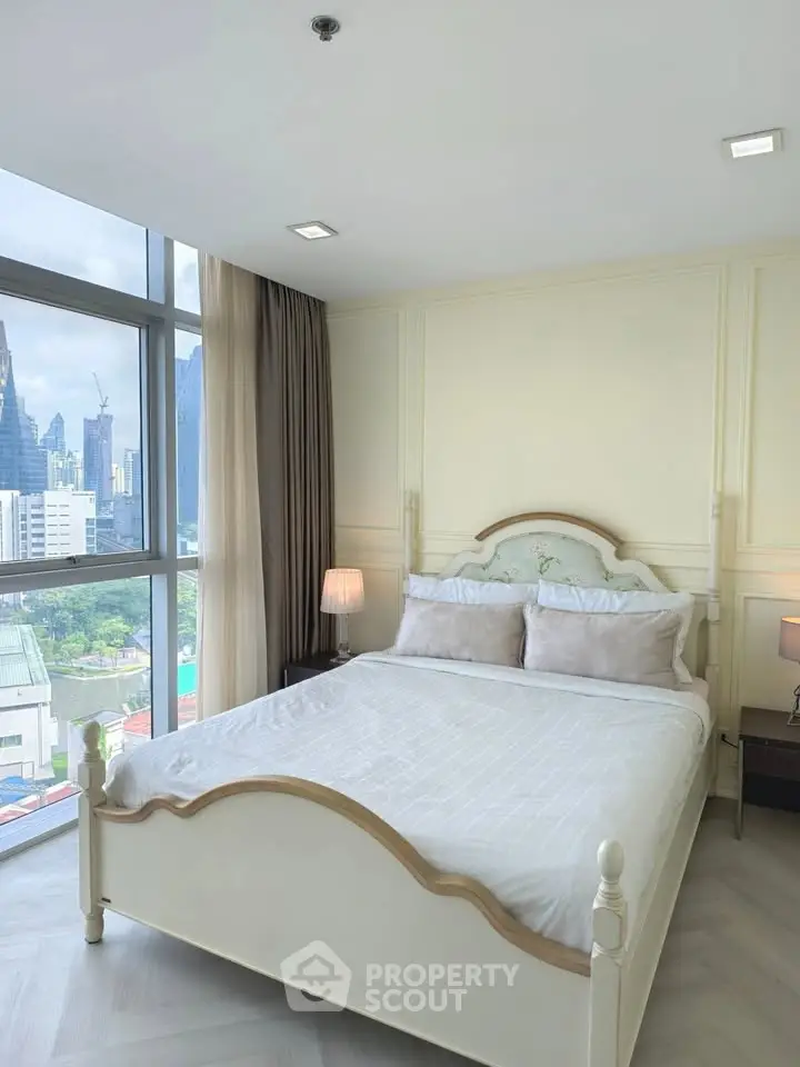 Bright bedroom with city view and elegant decor, featuring large windows and cozy ambiance.