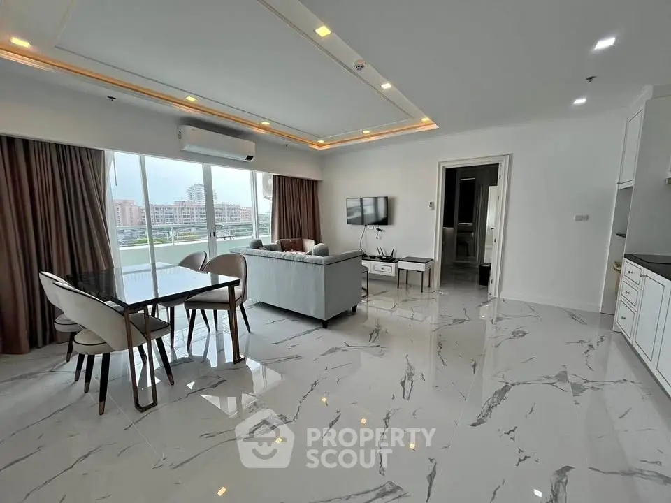 Spacious modern living room with marble flooring and large windows offering city views.