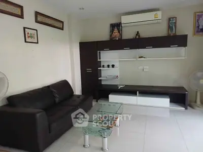 Modern living room with sleek furniture and air conditioning, perfect for comfortable living.