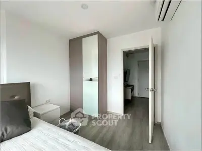 Modern bedroom with sleek wardrobe and minimalist decor