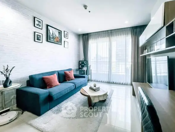 Modern living room with stylish decor, large windows, and cozy seating area.