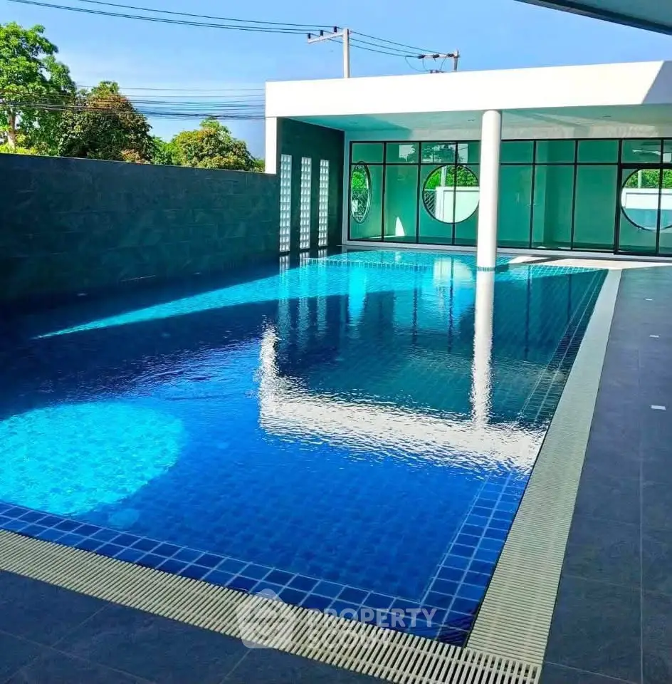 Luxurious indoor swimming pool with modern design and large windows offering serene views.